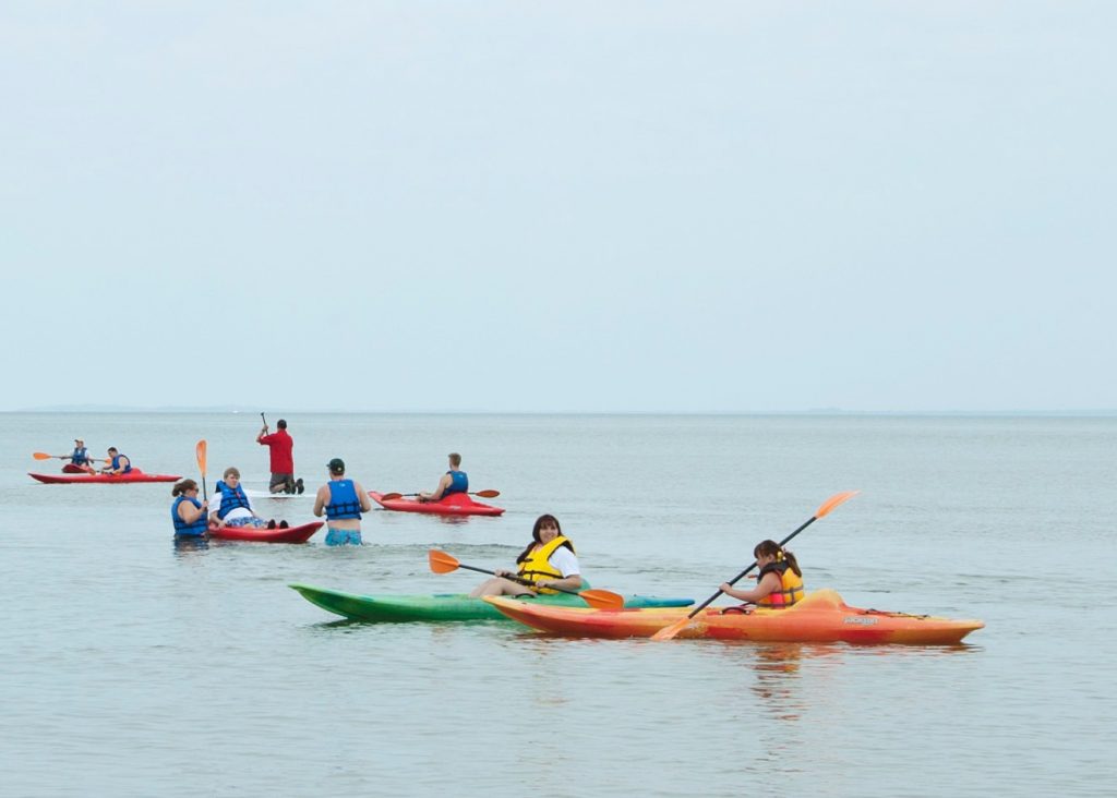 a group of people out on the water in kayaks