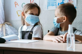 two girls in school wearing masks