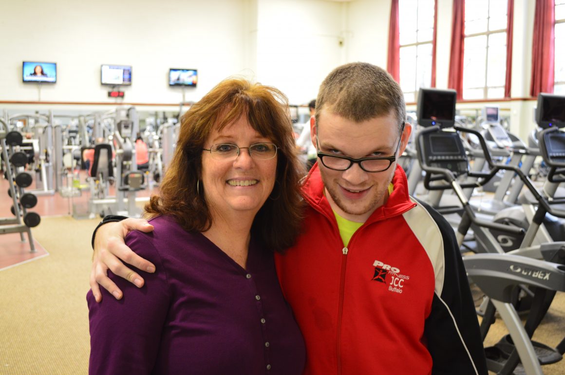 Woman and disabled young man in a gym