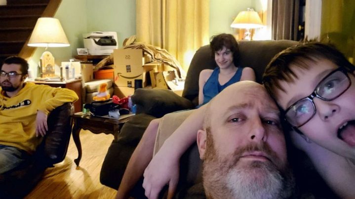 Gorski family in living room - Dad, two sons and daughter.