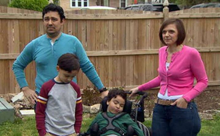 DeBatt family - Mom, Dad, and two sons in back yard.