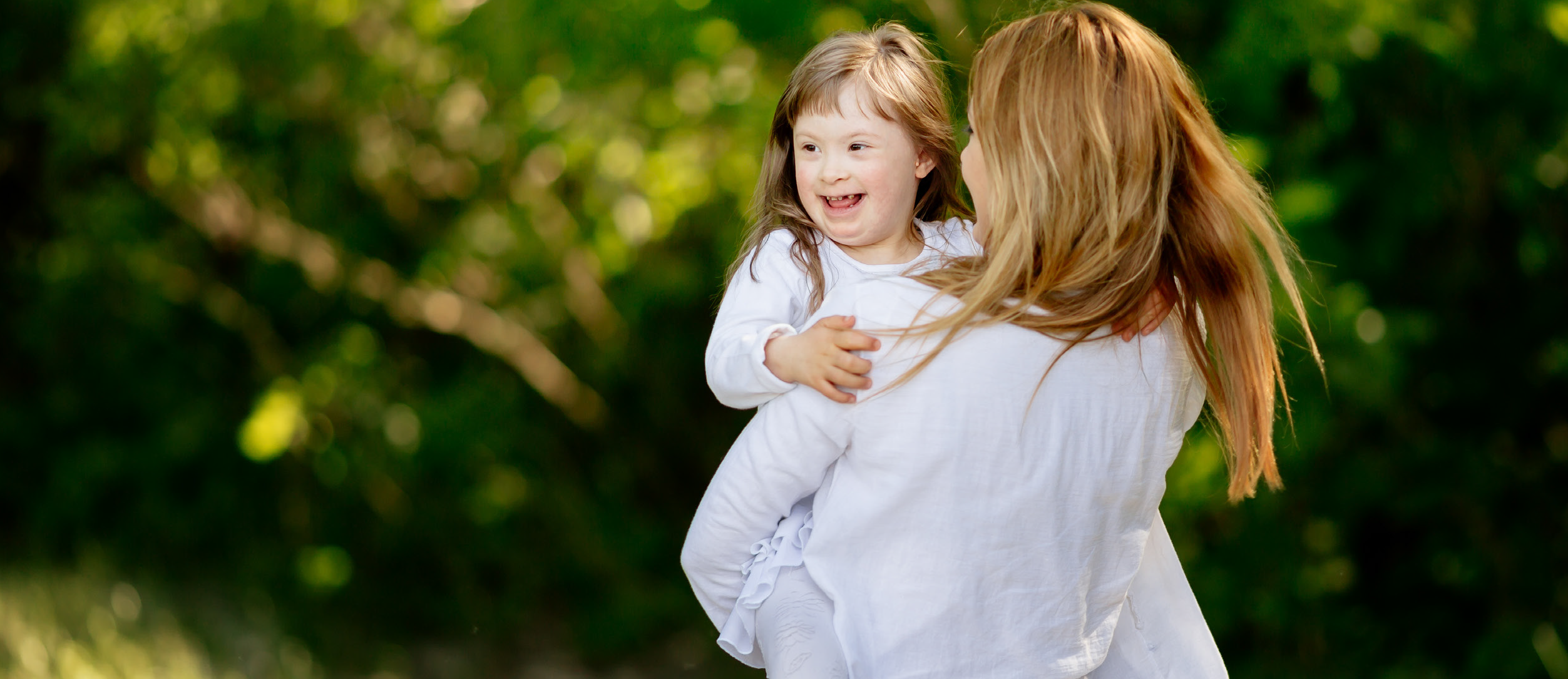 mom holding daughter