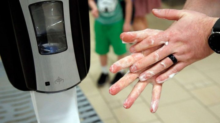 picture of hands using hand sanitizer