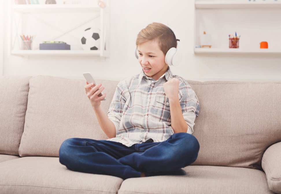 boy on phone with headphones