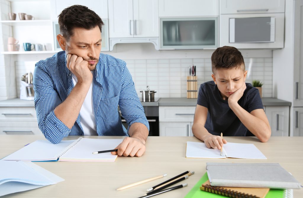father and son frustrated doing work at home