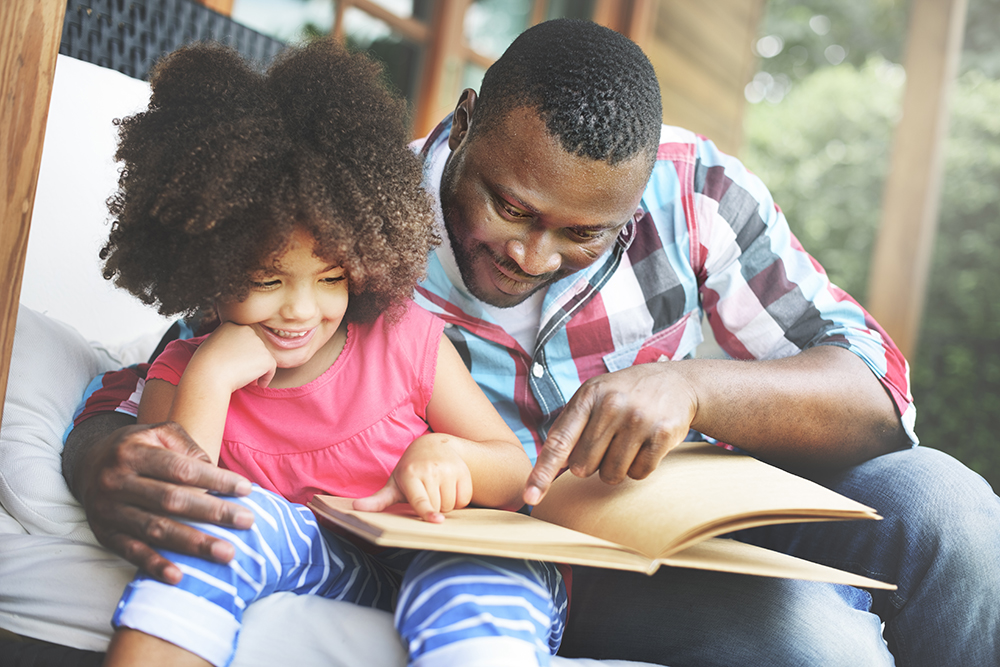 dad reading to daughter