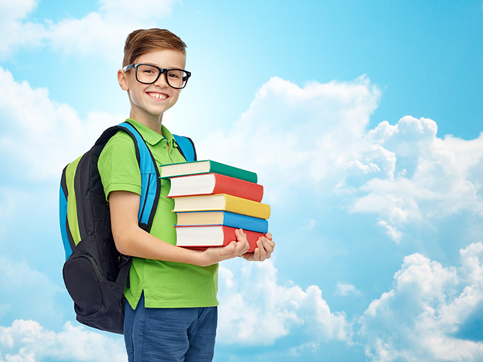 Boy holding stack of books
