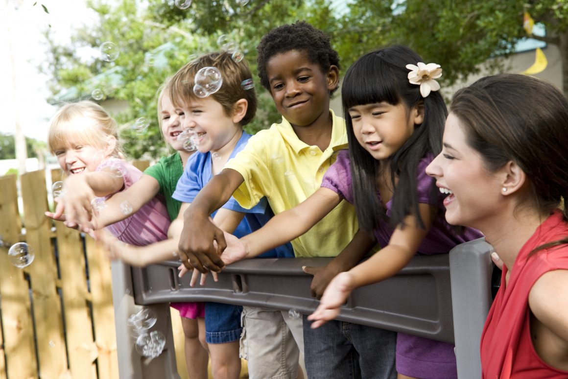 group of kids enjoying the summer with adult woman