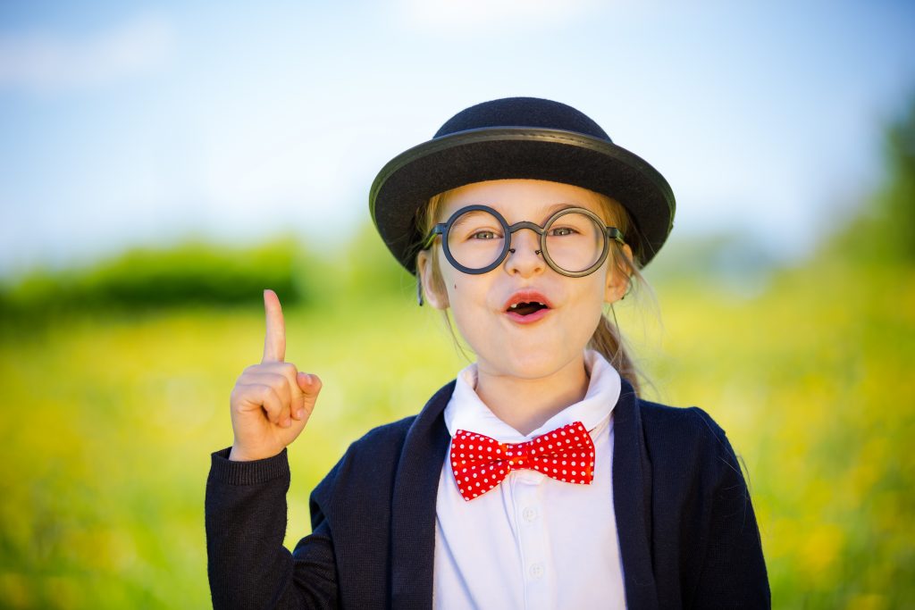 little girl dressed up in bowtie hat and glasses