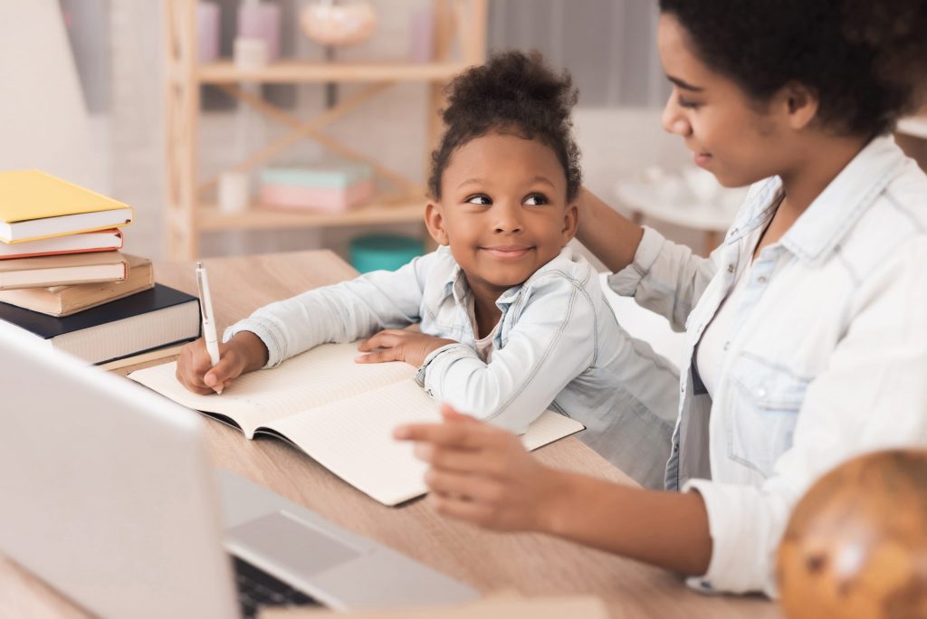 mom and daughter working on school work at home
