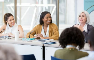 women presenting at a conference